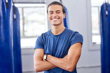 Personal trainer man, gym portrait and arms crossed with focus, wellness and health in workplace....