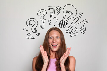Surprised mature brunette woman with question marks above her head. Idea, brainstorming, thinking concept