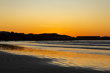 On the beach of Paternoster during sunset, orange sky, water, evening, Western Cape, South Africa