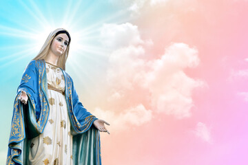 Fototapeta premium Statue of Our lady of grace virgin Mary with beautiful Sky Pastel with abstract colored background and wallpaper in sweet color. at Thailand.