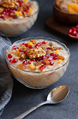 Traditional Turkish delicious mixed dessert, ashura (asure) with pomegranate seeds, walnut, apricot, Noah’s pudding