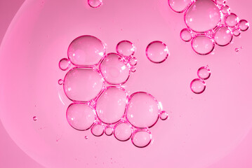Close up macro Aloe vera gel cosmetic texture pink background with bubbles. Lemongrass gel skincare product. antibacterial liquid with aloe vera, moisturizing. Safe and environmental friendly.