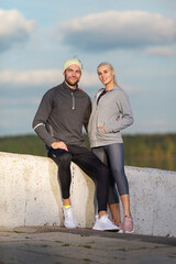 Jogging Concepts. Two Positive Caucasian Runners Athletes Relaxing During Training Together And Smiling As Fitness Exercise Outside While Training Outdoor Process.