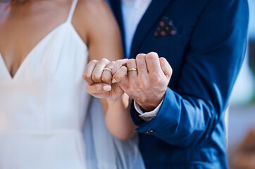 Hands, pinky promise and wedding ring of couple outdoor celebration of trust, partnership and love. Marriage commitment or loyalty of interracial bride and groom at ceremony to celebrate togetherness - obrazy, fototapety, plakaty