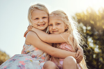 Hug, nature and portrait of girl siblings bonding, hugging and playing together in a park. Happy,...