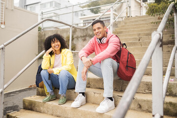 Portrait, stairs and students with a man and black woman sitting outdoor on campus together at university for education. Scholarship, college and school with a male and female pupil seated on steps