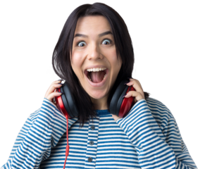 A young girl in a striped vest is listening to music in red headphones in a studio and dancing.