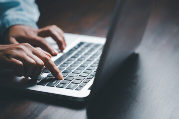 Woman person hands with laptop computer on wooden table for business or technology background.