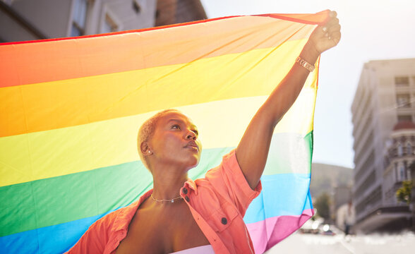 Lesbian, pride and black woman in city with flag for lgbtq community, ally or gay with support and equality in love outdoor. Rainbow, parade and lgbt awareness, inclusion and celebrate with sexuality