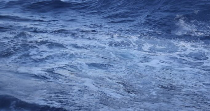 St Kitts Caribbean blue ocean waves from boat underwater. Destination vacation travel tropical sea. Caribbean cruise ship wake boat. Beautiful blue Ocean water wake behind large cruise ship.
