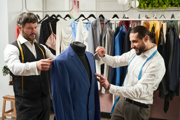 Two tailors focused on working in studio