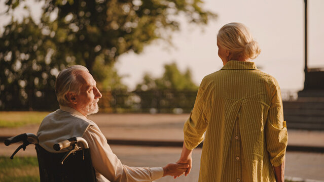 Senior Man With Disability And His Wife Holding Hands, Couple Facing Challenges Together