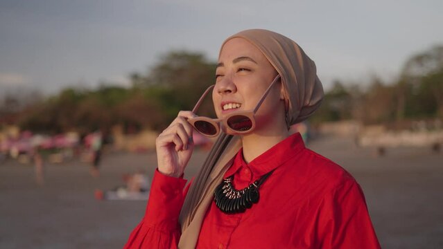 Modern Muslim Woman on Hijab Southeast Asian - Portrait, Smiling, looking to The Sunset. Beautiful Optimistic Hopefull Attractive Close Up