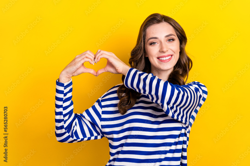 Sticker Photo portrait of attractive young woman toothy smile arms show heart feelings wear trendy striped look isolated on yellow color background