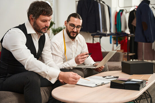 Experienced fashion designers working on new men clothing collection