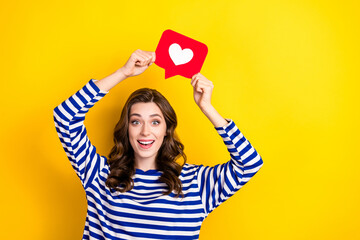 Photo of positive young excited woman brown curly hair wear striped stylish shirt hold paper like...