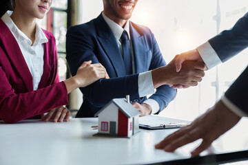 Close up of Real estate agent to buy houses and land are delivering keys and houses. Discussion with a real estate agent