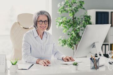 Photo portrait of senior woman entrepreneur toothy smiling analyzing company money worker director modern indoors inside home room