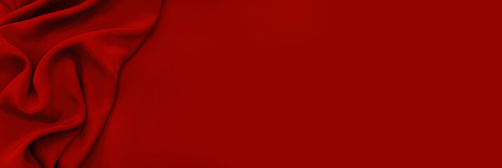 Dark red silk satin background. Bright folds on a shiny fabric. Valentine's Day. Luxury background with empty space for design. Top view web banner