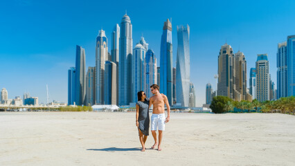 Couple on a citytrip to Dubai walking at the beach of Jumeirah beach Dubai United Arab Emirates