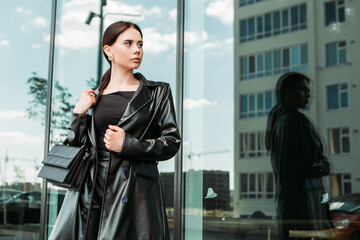 Pretty brunette caucasian woman dressed leather suit with shoulder bag walking outside street. Businesswoman hurry to work. Office CEO clerk. Confident serious lady. Professional business owner
