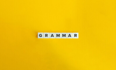 Grammar Word on Block Letter Tiles on Yellow Background. Minimal Aesthetics.