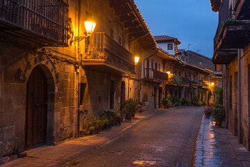 Fototapeta na wymiar Beautiful village of Cartes illuminated at night, in Cantabria, Spain.