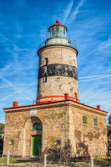 Falsterbo fyr or lighthouse on the Skanor peninusula, Skåne region, Sweden. Swedish or Scandinavian bricked lighthouse in Falsterbo is an historical landmark or building, anno 1796, in Skane county - obrazy, fototapety, plakaty