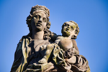 Statue of the Madonna attending to St. Bernard on Charles bridge, Prague. Czech Republic.