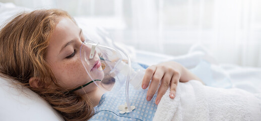 Portrait of little girl suffering from pneumonia lying in hospital bed with oxygen mask. Teenage kid patient with asphyxia breath in oxygen mask sleeping in bed at ward. Oxygen face mask of cute girl - obrazy, fototapety, plakaty