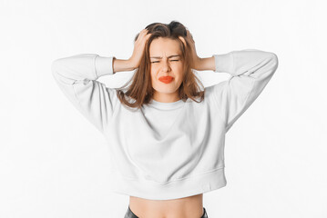 Image of shocked anxious woman in panic, grabbing her head and worrying, standing frustrated and scared against white background. Stress concept