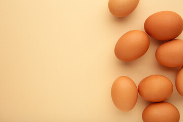 Chicken eggs on beige background. Farm products, natural eggs.
