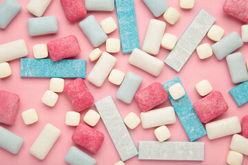 Different chewing gums on pink background.