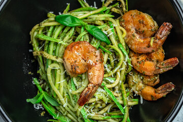 Zucchini raw pasta with pesto sauce and grilled shrimp cheese Parmesan, Restaurant menu, dieting, cookbook recipe top view