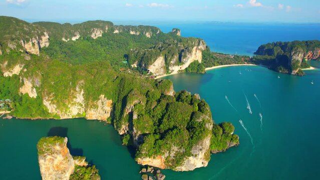 Amazing scenery over the tropical sea, beautiful limestone mountains. Long-tail boat is moving forward on the sea. Ao Nang, Krabi, Thailand. ocean background. High quality 4k footage. Drone nature
