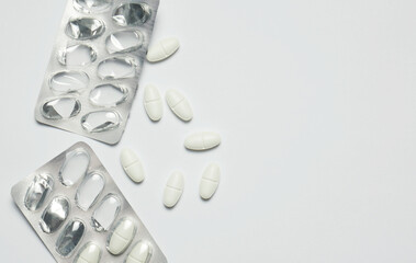 Top view, medicine, in tablets scattered on white background and space for copying.	