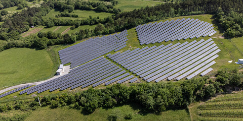 Solar electricity power plant located in nature - energy crisis conceptual aerial photo
