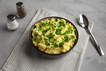Homemade Mashed Potatoes with Chives in a Bowl, side view.