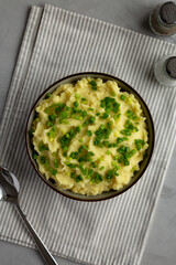 Homemade Mashed Potatoes with Chives in a Bowl, top view. Flat lay, overhead, from above.