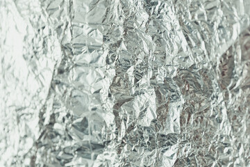 Defocused blurred silver foil as texture background and wrapping material