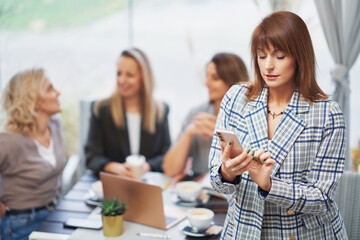 Picture of business woman with cell phone on meeting