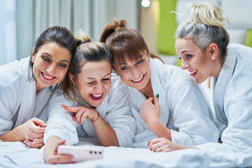 Girls at spa party in hotel with phone