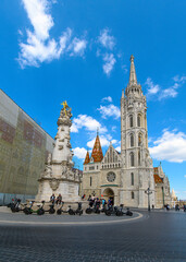 Fototapeta na wymiar Matthias Church, a church located in Budapest, Hungary, in front of the Fisherman's Bastion at the heart of Buda's Castle District. 