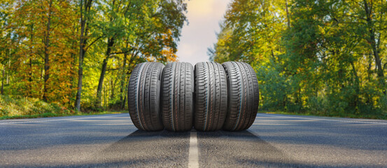 summer tires on the asphalt road in the sun - time for summer tires - obrazy, fototapety, plakaty