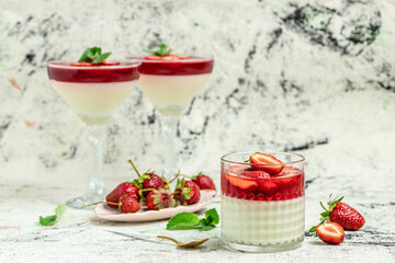 Panna cotta vanilla with strawberry sauce jelly and mint. Italian dessert, place for text
