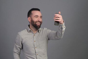 Young man taking a selfie in a studio shot - 565303198