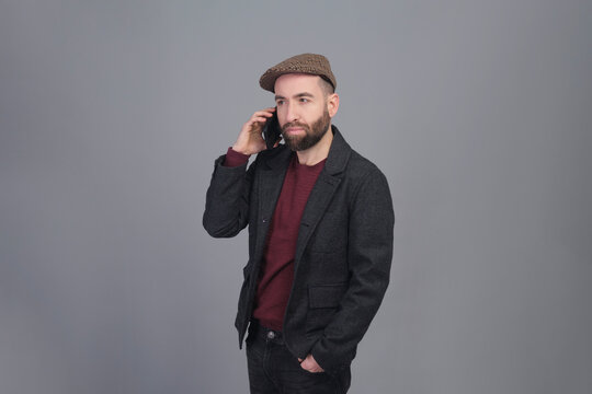 Young man talking on the phone in a studio shot