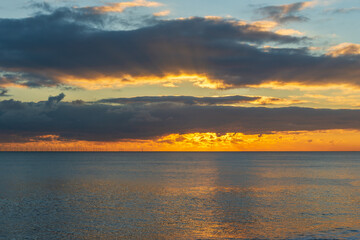 Fototapeta premium The sunsetting over the English Channel viewed from Brighton Beach, UK