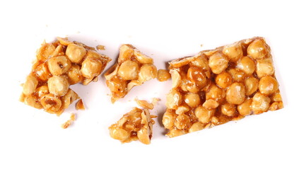Hazelnut caramelized nut, candied pieces nuts isolated on white, top view