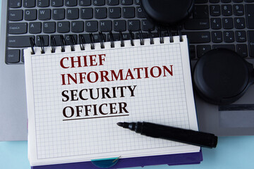 CHIEF INFORMATION SECURITY OFFICER - words on a white sheet on the background of a computer...